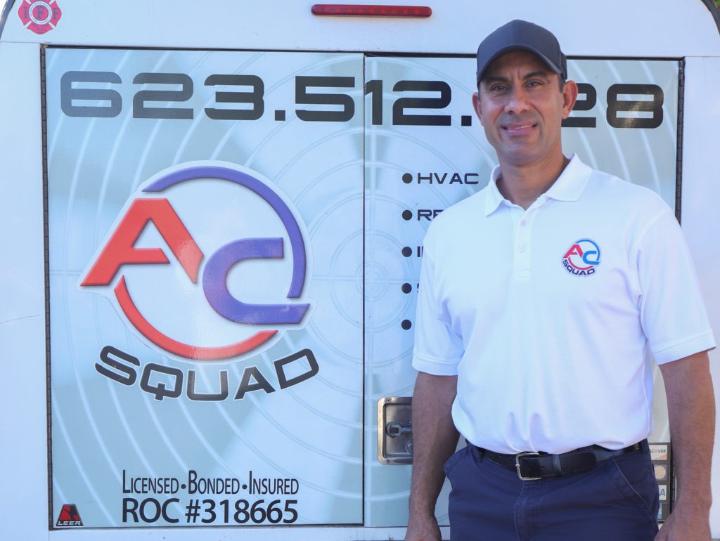 Lou Galindo, owner of A/C Squad LLC, standing in front of his branded service van
